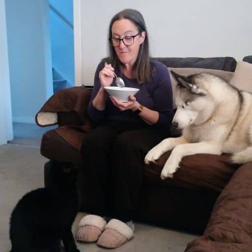 Daniella eating breakfast With Luna and Pickles watching her.